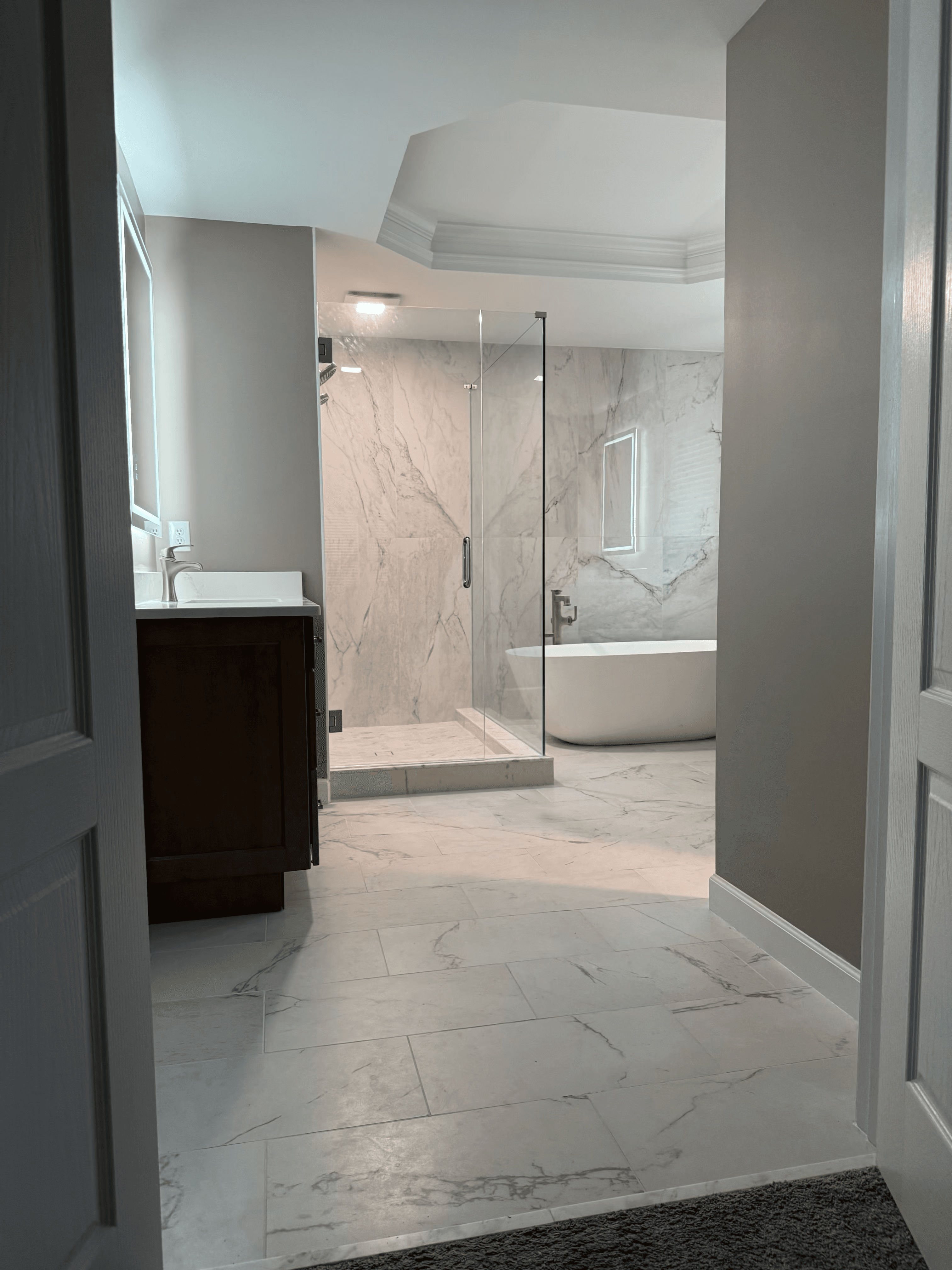Custom double vanity with warm tile accent wall